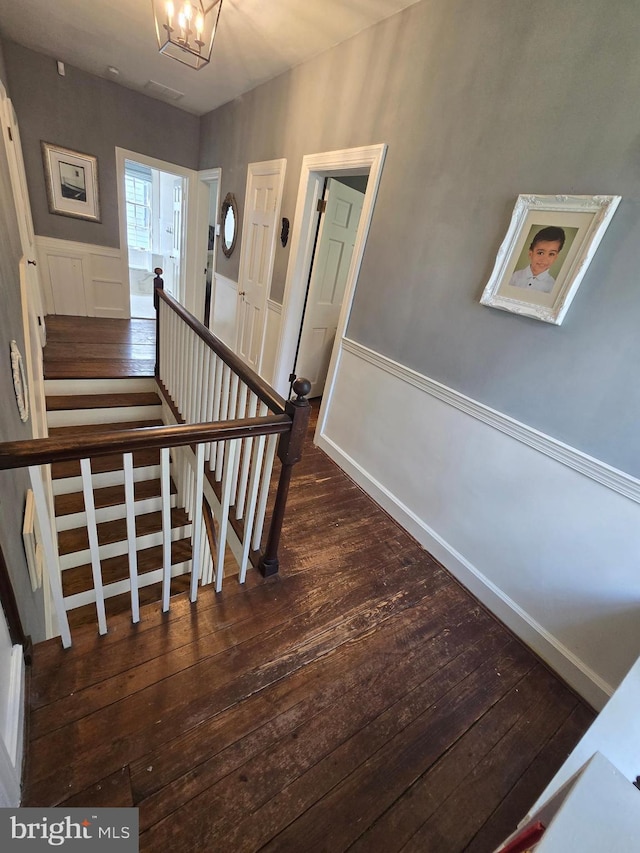 2531 Pickwick Rd, Baltimore, MD 21207 - staircase featuring wood finished floors, a decorative wall, and wainscoting