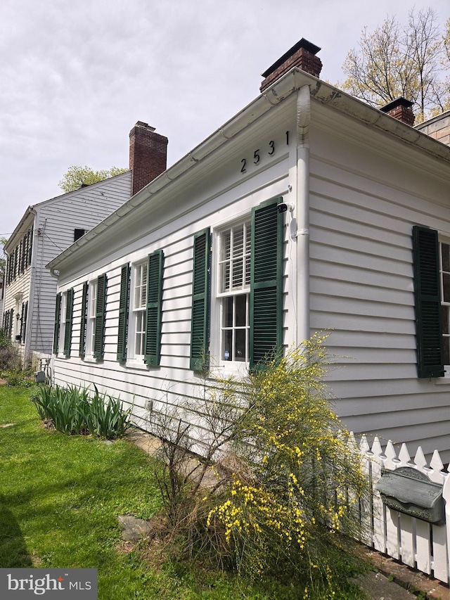 2531 Pickwick Rd, Baltimore, MD 21207 - view of side of property featuring a yard and a chimney