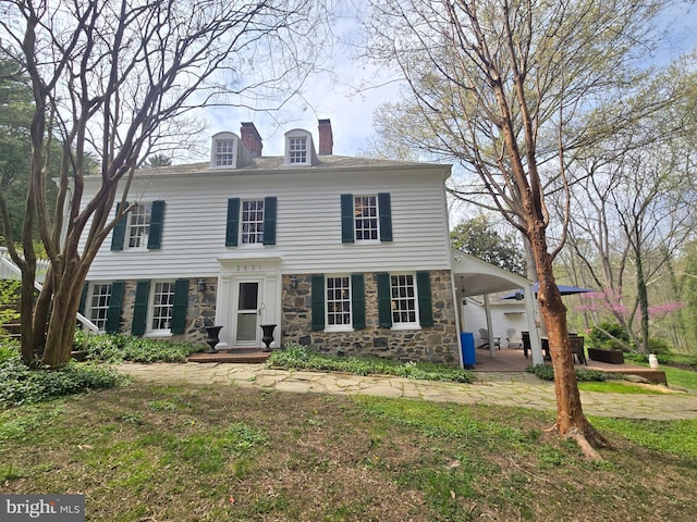 2531 Pickwick Rd, Baltimore, MD 21207 - view of front of house featuring stone siding and a chimney