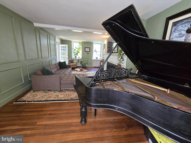 2531 Pickwick Rd, Baltimore, MD 21207 - sitting room with radiator, wood finished floors, and a decorative wall
