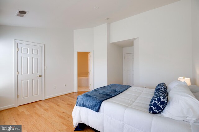 8114 Rainwater Cir, Manassas, VA 20111 - bedroom with baseboards, ensuite bathroom, visible vents, and light wood-type flooring