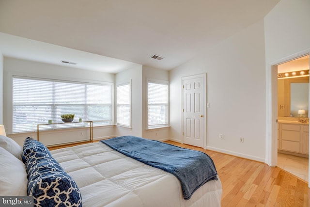 8114 Rainwater Cir, Manassas, VA 20111 - bedroom featuring light wood-type flooring, baseboards, ensuite bathroom, and visible vents