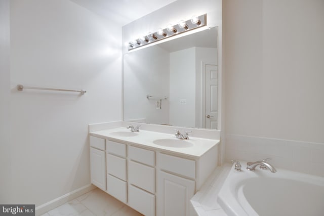 8114 Rainwater Cir, Manassas, VA 20111 - full bathroom featuring double vanity, a bath, baseboards, and a sink