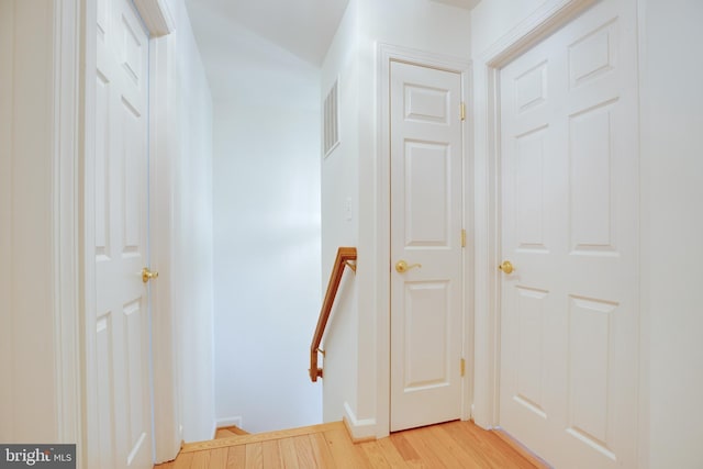 8114 Rainwater Cir, Manassas, VA 20111 - hall featuring baseboards, visible vents, an upstairs landing, and light wood finished floors