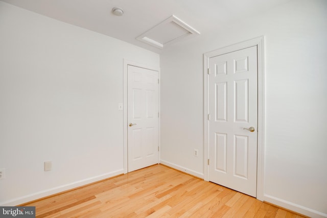 8114 Rainwater Cir, Manassas, VA 20111 - unfurnished bedroom featuring attic access, baseboards, and wood finished floors