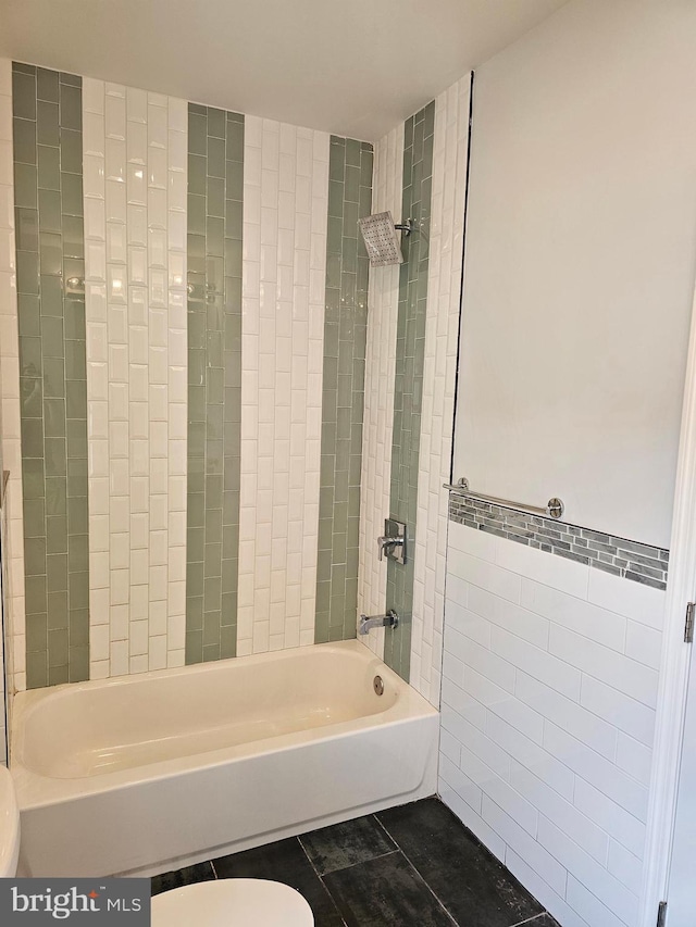 full bath featuring bathing tub / shower combination, toilet, and tile walls