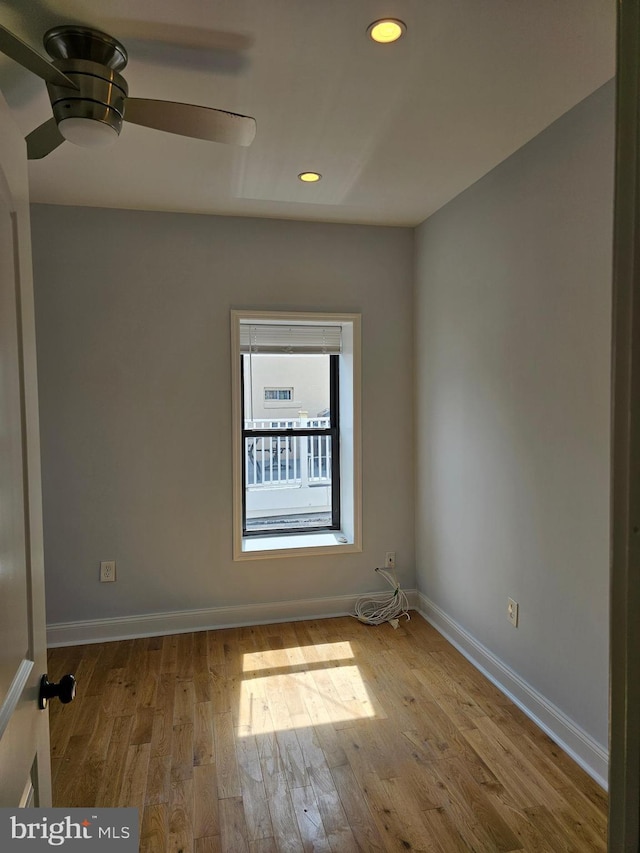 empty room featuring baseboards, recessed lighting, wood finished floors, and a ceiling fan