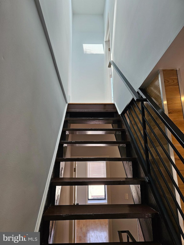 stairway featuring baseboards