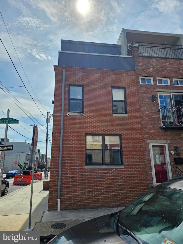 exterior space featuring brick siding