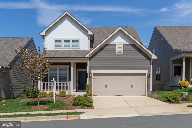 view of front facade featuring driveway, board and batten siding, a shingled roof, and covered porch