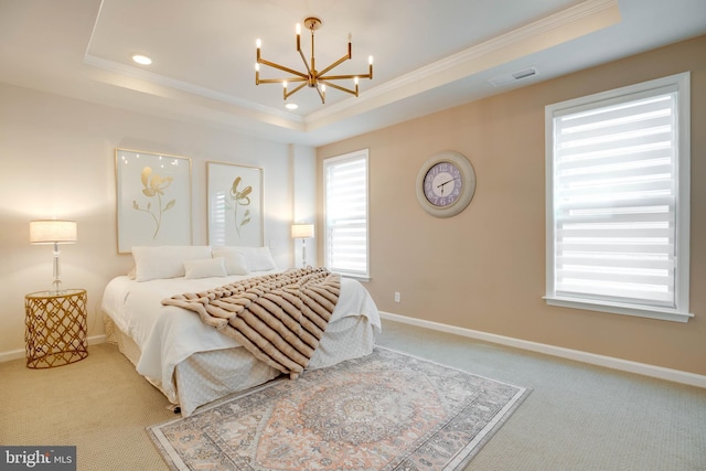 bedroom with visible vents, carpet flooring, an inviting chandelier, and a tray ceiling