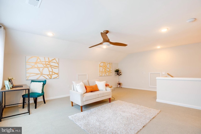 sitting room with lofted ceiling, visible vents, carpet flooring, and ceiling fan