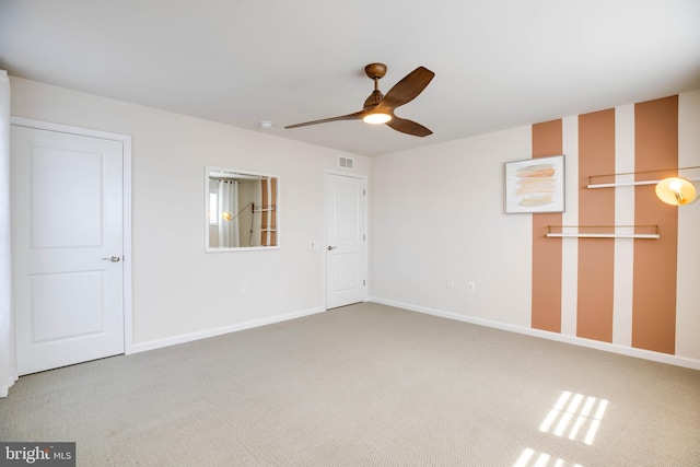 unfurnished bedroom featuring visible vents, baseboards, a ceiling fan, and carpet flooring