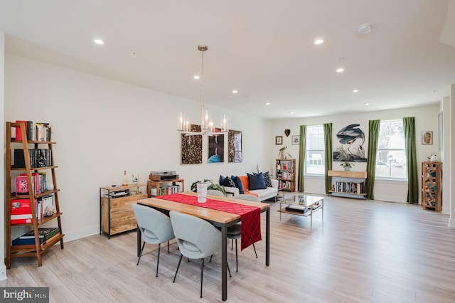 dining room with light wood finished floors, baseboards, an inviting chandelier, and recessed lighting