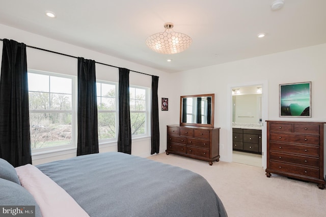 bedroom featuring light colored carpet, ensuite bathroom, and recessed lighting