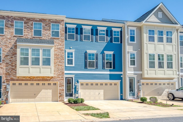 townhome / multi-family property with a garage and driveway