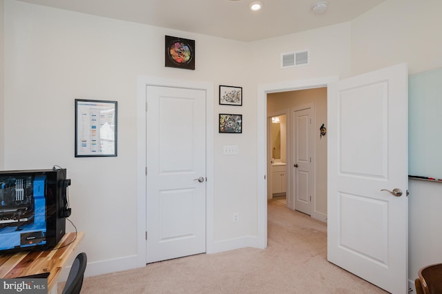 bedroom with visible vents, baseboards, and light carpet