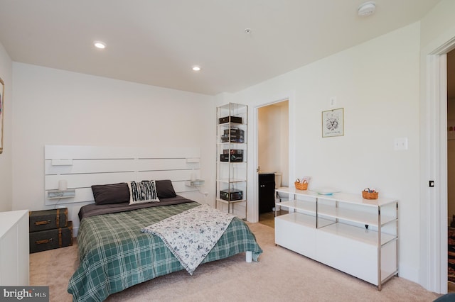 bedroom featuring light carpet and recessed lighting
