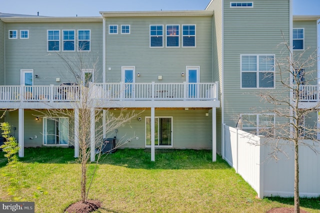 back of house with a yard, fence, a deck, and central AC