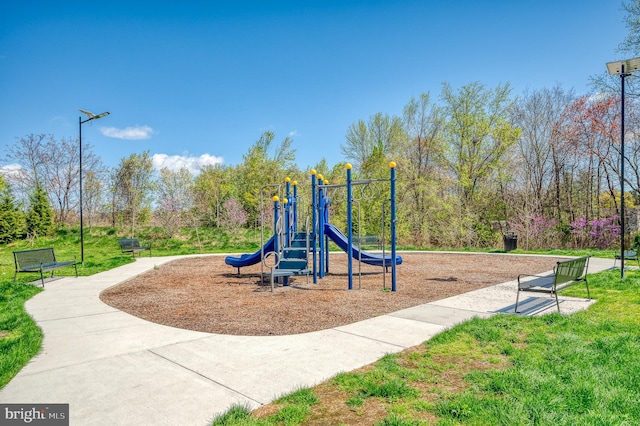 community playground featuring a lawn