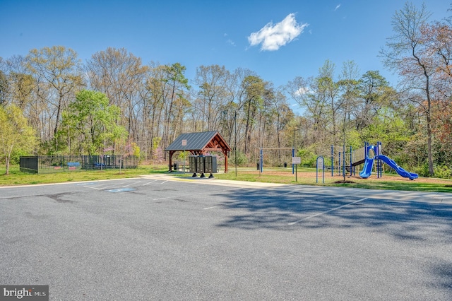 communal playground featuring a gazebo and fence