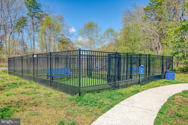 view of property's community featuring fence and a lawn