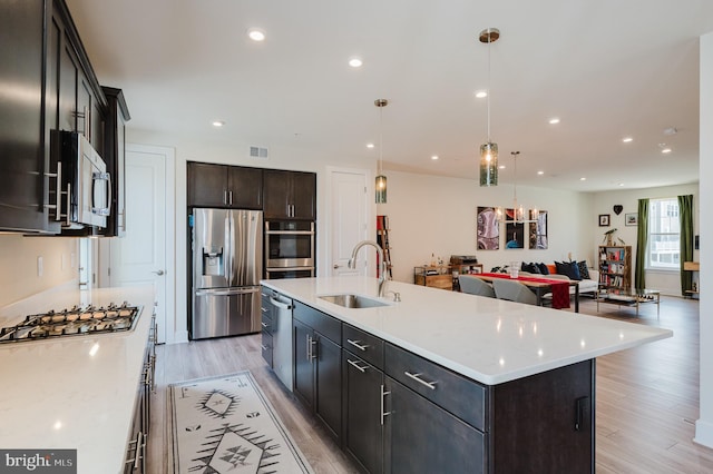 kitchen with light wood-style flooring, visible vents, recessed lighting, appliances with stainless steel finishes, and a sink