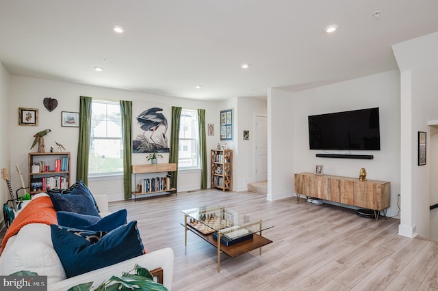 living room with light wood-type flooring, baseboards, and recessed lighting