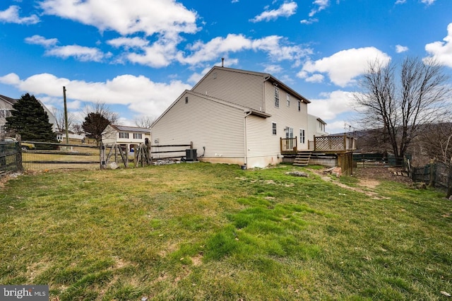 exterior space featuring a fenced backyard, a wooden deck, cooling unit, and a lawn