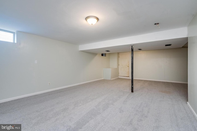 below grade area with baseboards and carpet