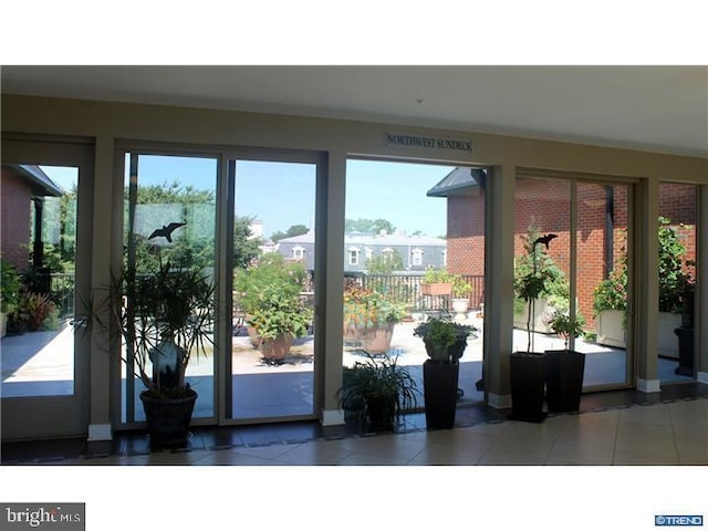 doorway to outside with tile patterned flooring