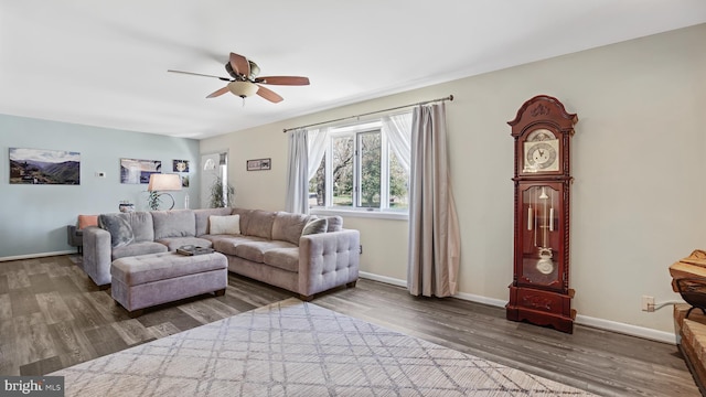 living area with wood finished floors, ceiling fan, and baseboards