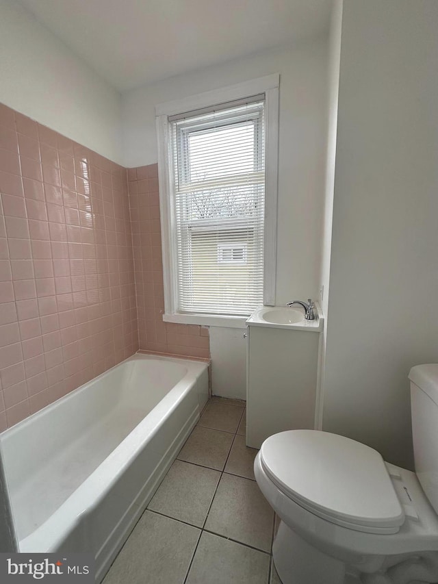 full bathroom with a bathing tub, toilet, tile patterned flooring, and vanity