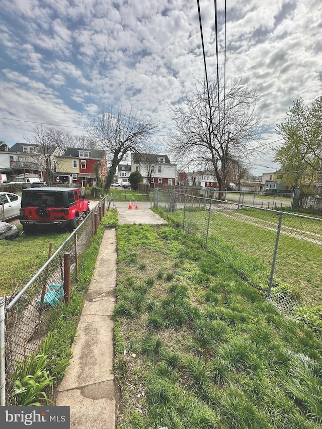 view of yard with a residential view and fence