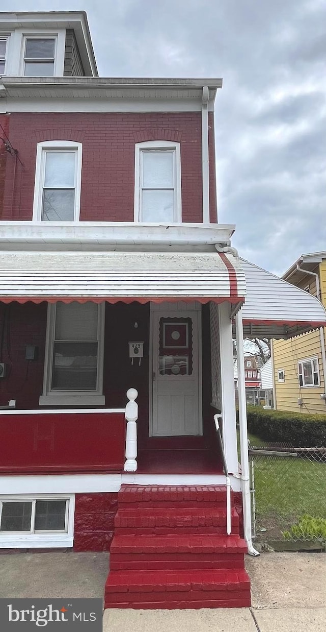 view of front of property with brick siding and covered porch