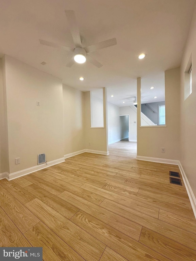 below grade area with light wood-style floors, ceiling fan, baseboards, and recessed lighting
