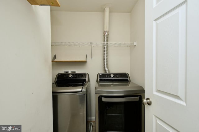 laundry area with separate washer and dryer and laundry area