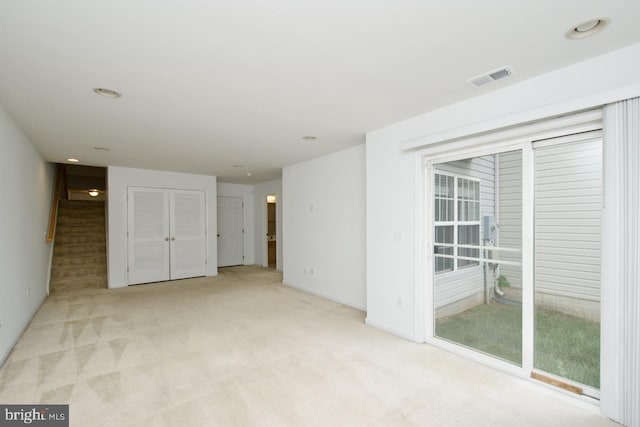 spare room with light colored carpet, baseboards, visible vents, and recessed lighting