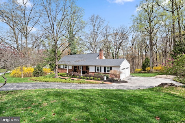 ranch-style home featuring a front lawn, brick siding, driveway, a chimney, and an attached garage
