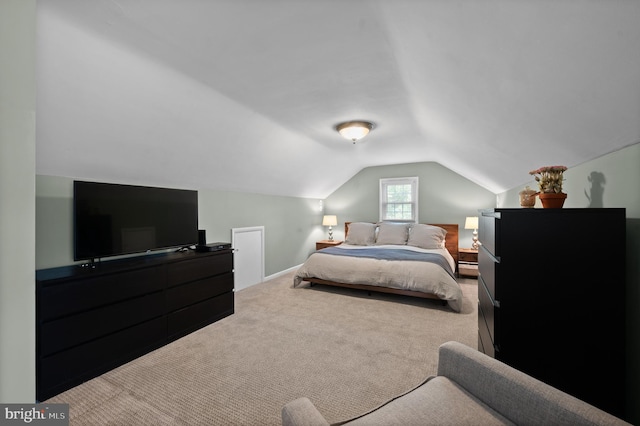 carpeted bedroom with lofted ceiling