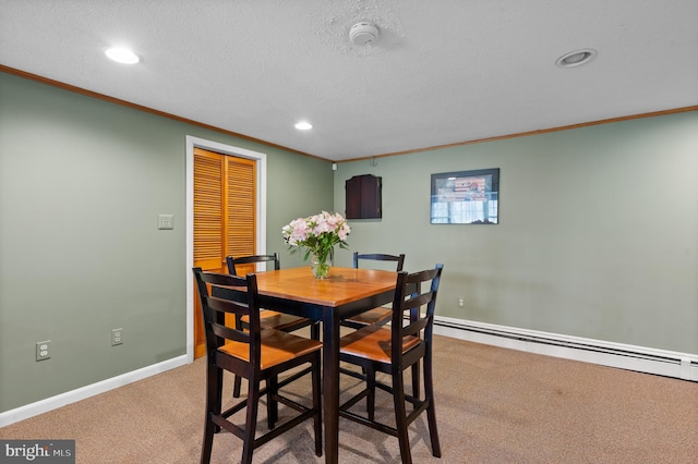 carpeted dining space with a textured ceiling, a baseboard heating unit, baseboards, recessed lighting, and ornamental molding