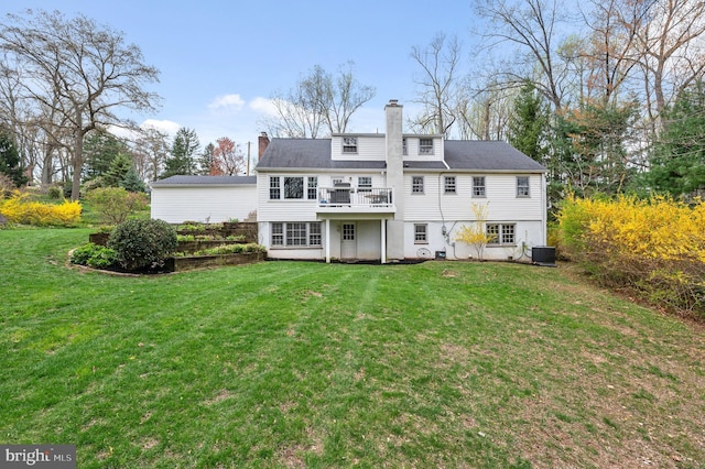 rear view of house featuring a wooden deck, a yard, a chimney, and central AC unit