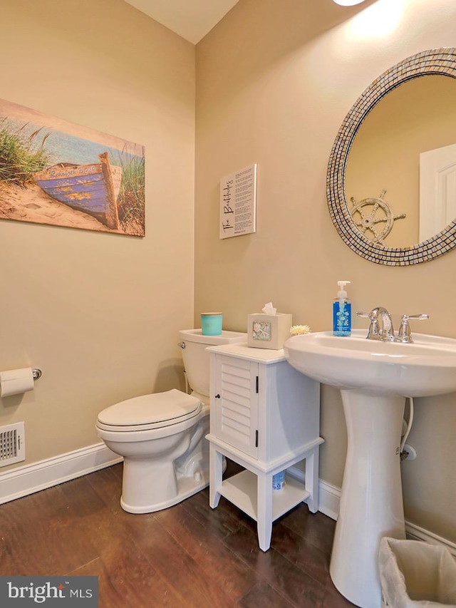 169 E Buckingham Dr, Rehoboth Beach, DE 19971 - bathroom featuring wood finished floors, baseboards, and toilet
