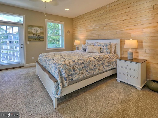 169 E Buckingham Dr, Rehoboth Beach, DE 19971 - carpeted bedroom featuring wood walls, access to exterior, recessed lighting, and baseboards