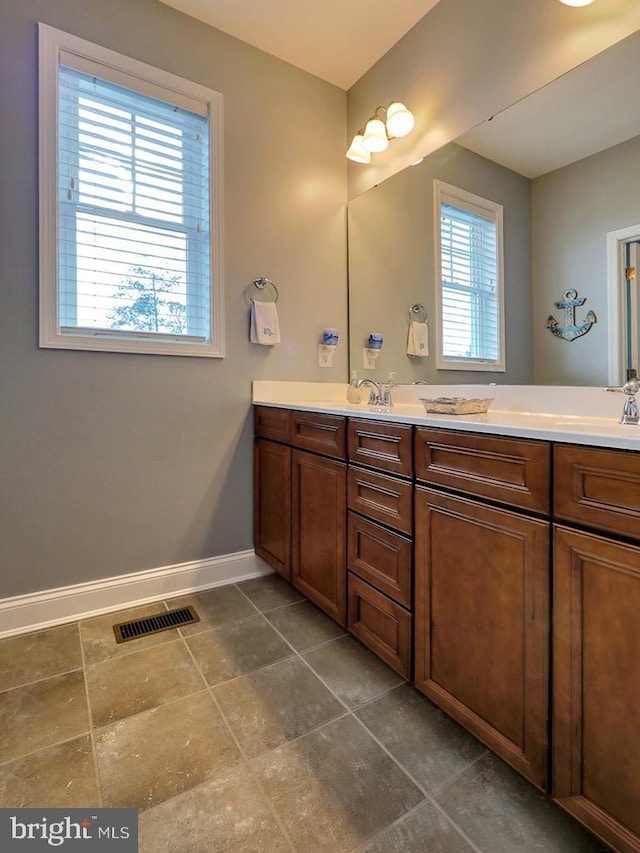 169 E Buckingham Dr, Rehoboth Beach, DE 19971 - full bathroom with baseboards and double vanity