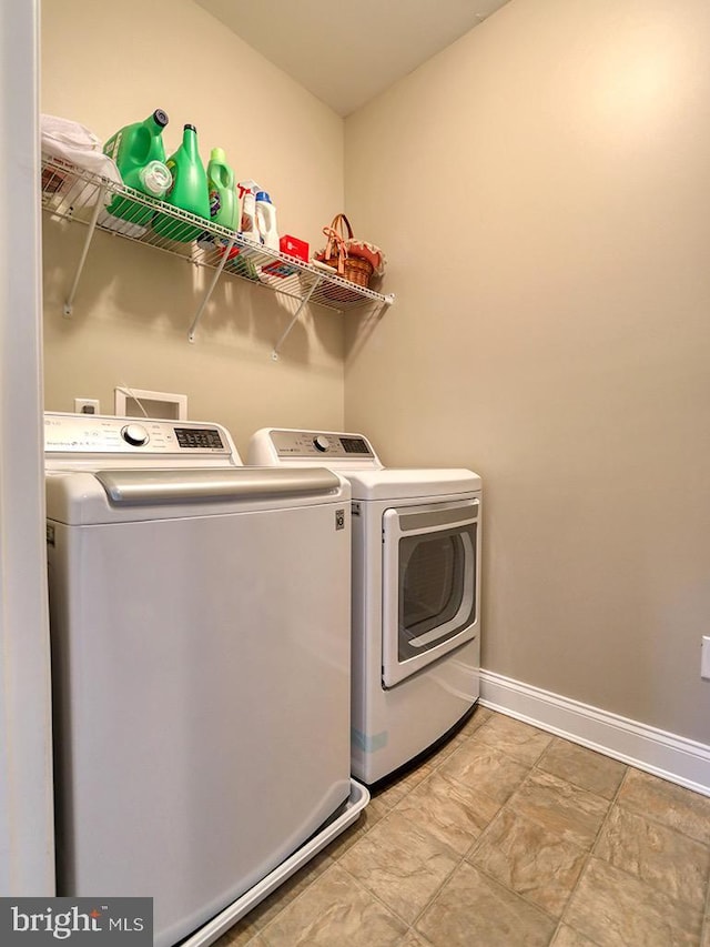 169 E Buckingham Dr, Rehoboth Beach, DE 19971 - laundry area featuring washing machine and dryer and baseboards