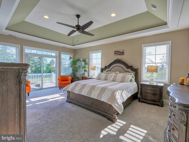 169 E Buckingham Dr, Rehoboth Beach, DE 19971 - bedroom featuring a tray ceiling, access to exterior, light carpet, recessed lighting, and a ceiling fan