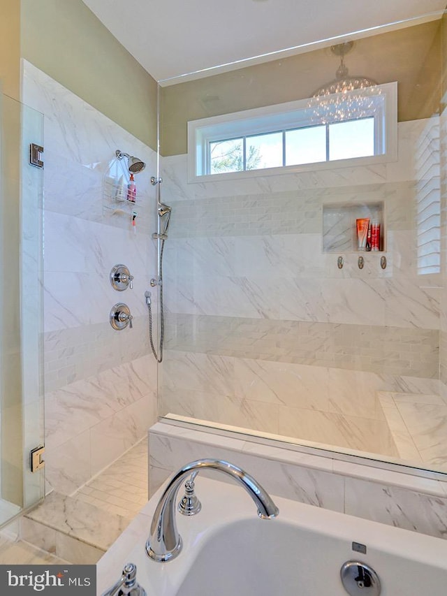 169 E Buckingham Dr, Rehoboth Beach, DE 19971 - full bath featuring a bath, a tile shower, a sink, and a chandelier