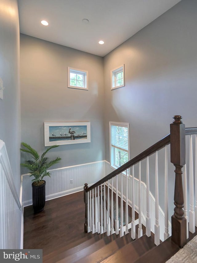 169 E Buckingham Dr, Rehoboth Beach, DE 19971 - stairway featuring wood finished floors, wainscoting, recessed lighting, and a towering ceiling
