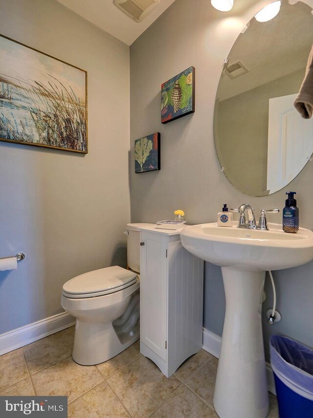 169 E Buckingham Dr, Rehoboth Beach, DE 19971 - half bathroom featuring baseboards, toilet, and tile patterned flooring